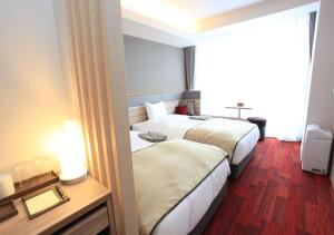 Voodi või voodid majutusasutuse Urban Hotel Kyoto Gojo Premium toas