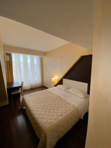 Letto o letti in una camera di E' Hotel