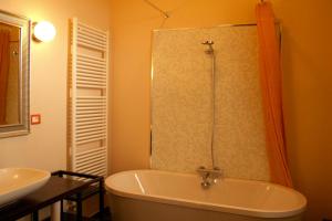 a bathroom with a bath tub and a sink at B&B Casa Bologna in Bologna