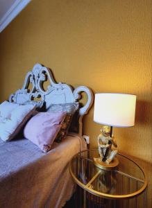 a bedroom with a bed and a table with a lamp at Ocean Wave by TOR in Puerto de la Cruz