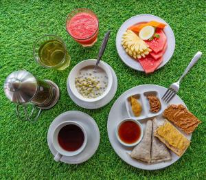 a white plate topped with different types of food at Serenity Eco Guesthouse - CHSE certified in Canggu