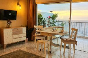 a dining room with a table and a view of the ocean at Ocean Wave by TOR in Puerto de la Cruz
