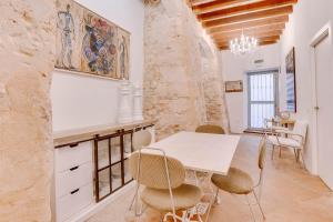 a dining room with a white table and chairs at Vintage Palma Palace Apartments TI by PriorityVillas in Palma de Mallorca