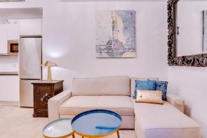 a living room with a couch and a table at Vintage Palma Palace Apartments TI by PriorityVillas in Palma de Mallorca +24 photos