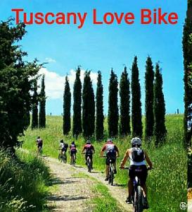a group of people riding bikes down a dirt road at Bed and Breakfast Val Di Lupa in Castellina Marittima