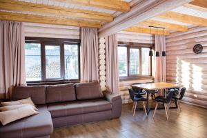 a living room with a couch and a table at Шале Вілія in Vorokhta