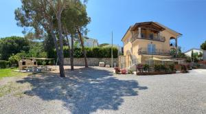 a house with a tree in front of a building at Villa Mia in Capoliveri