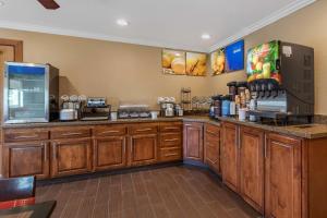 a kitchen with wooden cabinets and a counter top at Comfort Inn Fontana in Fontana