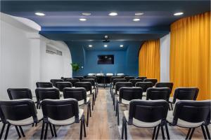 a conference room with chairs and a table in the middle at Hotel Tim's in Skopje