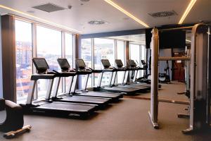 a gym with a row of tread machines in a building at Crowne Plaza Hobart, an IHG Hotel in Hobart