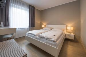 Postel nebo postele na pokoji v ubytování Hotel Hiltruper Hof