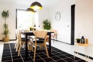 a dining room with a black table and chairs at Regouro - an Hidden Gem in Douro Valley in Boassas
