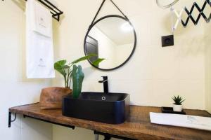 a bathroom with a black sink and a mirror at Regouro - an Hidden Gem in Douro Valley in Boassas