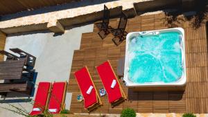 a swimming pool on the side of a building with chairs at Ankora apartments sea and Old Town view - HOT TUB in Dubrovnik