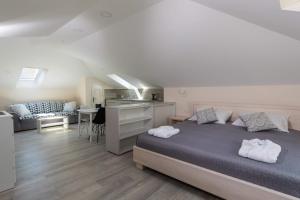 a bedroom with a bed with two towels on it at Villa Enigma in Dubrovnik +18 photos