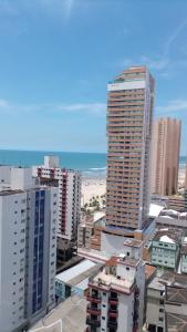 a view of a city with tall buildings and the ocean at Studio unita143 in Praia Grande