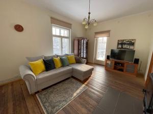 a living room with a couch and a tv at Pühajärve residents in Otepää