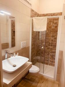a bathroom with a toilet and a sink and a shower at Appartamento Bax 1 in Francavilla Fontana