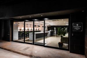 a store front with large glass windows in a building at Randor Hotel Namba Osaka Suites in Osaka