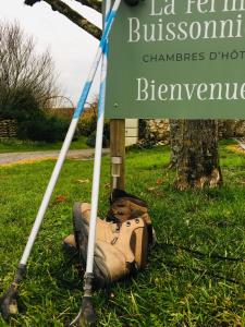 a sign with a teddy bear laying on the grass at La Ferme Buissonnière in Bardou