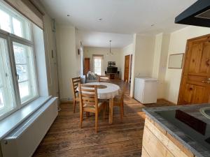 a kitchen and dining room with a table and chairs at Pühajärve residents in Otepää