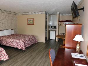 a small hotel room with a bed and a table at Valley Inn - Hamilton Ga in Hamilton