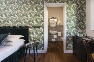 a bedroom with a bed and a bathroom with a sink at Parione Uno in Florence