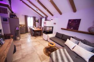 a living room with a couch and a table at Chalet Dorfalm in Maria Alm am Steinernen Meer