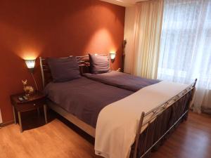 a bedroom with a large bed and a window at Appartement de Gouw in Noordgouwe