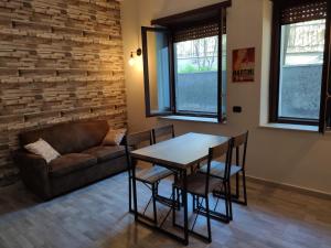 a living room with a table and chairs and a couch at La Dimora dei Consoli - Holiday House a Roma vicino San Pietro in Rome