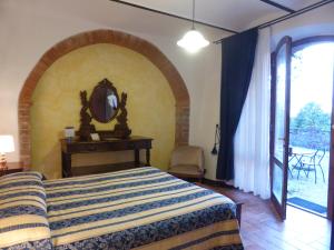 a bedroom with a large bed and a large window at Fattoria del Colle in Trequanda