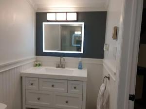 a bathroom with a sink and a mirror at 180 SKI CAMELBACK-SKI-ON -SKI OFF,SNOW TUBING,Paintball in Tannersville
