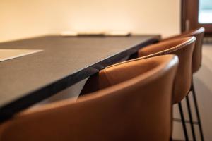 a row of chairs around a table in a conference room at Chalet Pinnacle in Saas-Fee