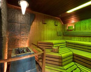 a green sauna with green seats in a room at Scandic Berlin Kurfürstendamm in Berlin