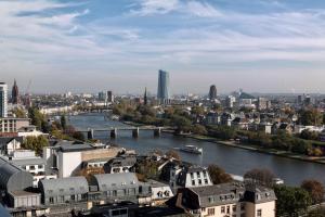 a city with tall buildings and a river at Scandic Frankfurt Museumsufer in Frankfurt