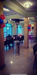 a restaurant with a trash can in the middle of a room at Hotel Sanjeevny in Bajaura