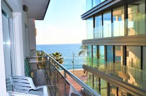 a balcony of a building with a view of the ocean at Apartaments Tropic in Lloret de Mar