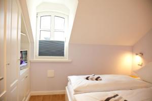 ヴェスターラントにあるStadtjuwel, App 3のベッドルーム(ベッド1台、窓付)