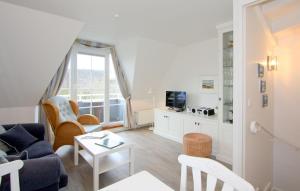 a living room with a couch and a table at Haus Dünenrand, App 2 in Wenningstedt