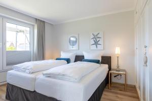 Ένα ή περισσότερα κρεβάτια σε δωμάτιο στο Haus Weissenburg, Whg EG West