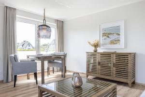 ヴェニングシュテットにあるHaus Weissenburg, Whg EG Ostのテーブルとダイニングルームのあるリビングルーム