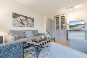 TV a/nebo společenská místnost v ubytování Strandgut Wohnung 5