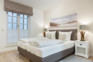 Postel nebo postele na pokoji v ubytování Strandgut Wohnung 5