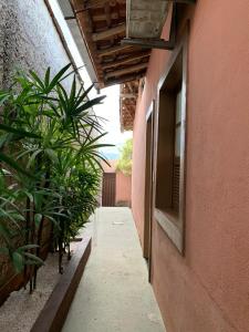 a hallway with plants next to a building at Kitnet - Apart Hotel 3 in Sete Lagoas