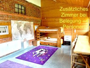 a room with two bunk beds and a map on the wall at Seaside‘s Villa Kunterbunt in Scharbeutz