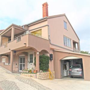 a house with a car parked in front of it at Cosy apartment on the Beach - Kali in Kali