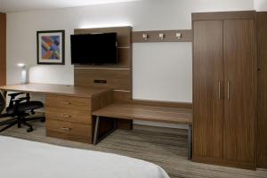 a bedroom with a television and a bed at Holiday Inn Express Lake Okeechobee, an IHG Hotel in Okeechobee