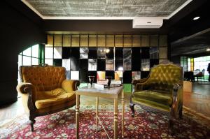 
a living room with a couch, chairs and a rug at Hotel Clasico in Buenos Aires
