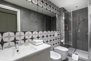 a bathroom with a sink and a toilet and a shower at The Vatican ONE in Rome +6 photos