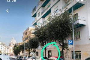 a parking meter with a green circle next to a building at The Vatican ONE in Rome